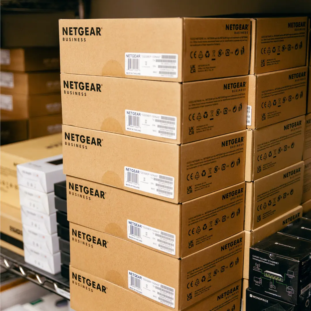 Stacks of boxes labeled "NETGEAR BUSINESS".